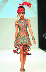 A model displays a creation by designer Deepak Perwani during the first-ever Pakistan Fashion Week in Karachi on Saturday.