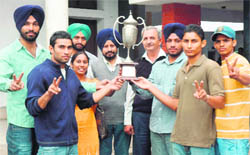 The team of Multani Mal Modi College with the trophy after winning the Punjabi University Boxing Championship in Patiala on Monday.