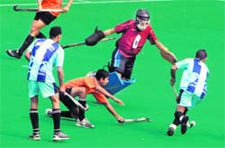 Players of Government Model High School, Sector 42, and Union Academy Senior Secondary School, New Delhi, in action during a match at the Hockey Stadium, Sector 42, in Chandigarh on Monday.