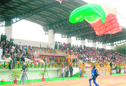 A paratrooper lands at the venue of the state Foundation Day function in Dehradun