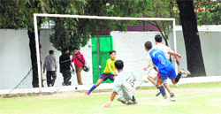 The goalkeeper attempts to save a goal at the Coca Cola Cup Sub-Junior Football Tournament at Welham Boys School in Dehradun