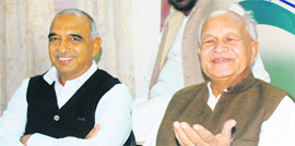 Congress president Phool Chand Mullana, along with Sampat Singh, addresses a press conference in Chandigarh on Monday.