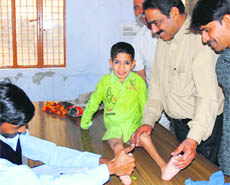 Doctors examine a patient at a camp in Karnal.
