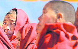 Buddhist monks listen to a speech by Tibetan spiritual leader the Dalai Lama in Tawang, Arunachal Pradesh, on Monday.