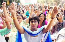 Employees of different state government departments posted in Gurgaon stage a protest demonstration in front of the mini-secretariat in Gurgaon on Monday.
