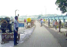 A traffic policeman regulates traffic at the under repair bridge in Ropar.