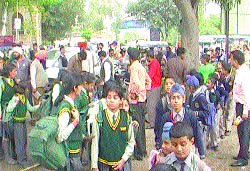 Schoolchildren wait for their turn to cross the bridge. 