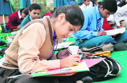 Students take part in a painting competition at Alpine International school in Ludhiana on Monday. 