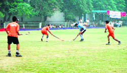 Players in action during a hockey match in Doraha on Monday.