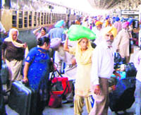 Pilgrims returning from Nankana Sahib alight from the Samjhauta Express at Attari railway station on Monday.