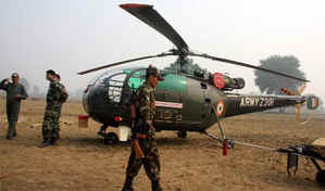 The Army helicopter that force landed in village Geri-Butter near Bathinda on Monday because of poor visibility due to smog. Soldiers stand guard as it was unable to take off till late afternoon on Tuesday. 