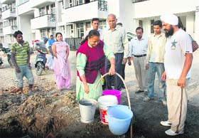 Due to technical fault in the water fitting in flats, allottees of the CHB complex in Sector 49, Chandigarh, are forced to fetch water from a nearby tubewell