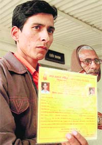 Rajinder Satlani shows his marriage certificate issued by a temple at the Burail police post in Chandigarh
