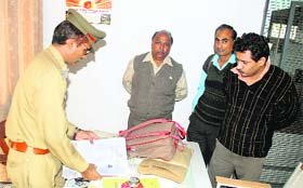 PU security staff recover forms from the bags of suspected touts