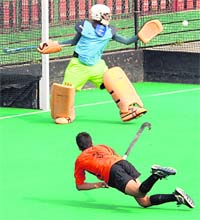 A player flicks the ball to the goal of an opposing team during the 38th ATS Nehru Junior Hockey (Under-17) Tournament at the Hockey Stadium, Sector 42, Chandigarh
