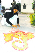 A student makes a rangoli at Kanya Gurukul Maha Vidyalaya in Haridwar.