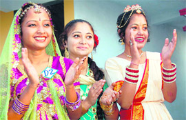 Three participants applaud at a cultural programme during the annual day celebrations of the Uttaranchal College of Science and Technology in Dehradun on Tuesday.
