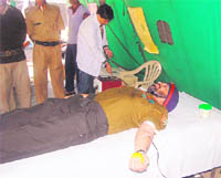 An NCC officer donates blood at a camp in Dehradun on Tuesday. 