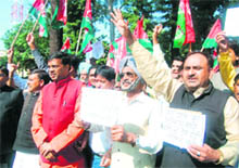 Samajwadi Party workers protest against assault on their party legislator in the Maharashtra Assembly in Dehradun on Tuesday. 