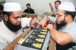 Karigars at work in one of the badge-making units at Malerkotla.