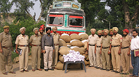 Police officials with the seized contraband in Kapurthala on Tuesday.