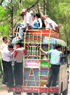 An overloaded mini-bus in Jammu.