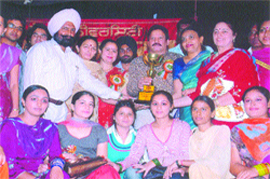 Students and teachers of Master Gurbanta Singh Memorial Janata College hold winners trophy of zonal youth festival