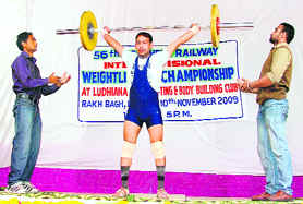 A participant makes a successful attempt at the 56th Northern Railway Inter-division Weightlifting Championship in Ludhiana on Tuesday. 