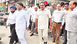 Shopkeepers of Ghumar Mandi come out of MLA Harish Rai Dhandas office in Ludhiana on Tuesday. 