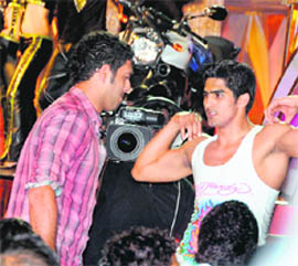 Boxer Vijender Singh shows his musculature to Yuvraj Singh during a sports awards function, in Mumbai on Monday night.