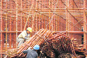 Migrant labourers work at a construction site near Hongqiao Airport in Shanghai on Wednesday. Chinese factory output growth surged to a 19-month high in October, showing the world's third-largest economy has firmly put the worst of the global financial crisis behind it.