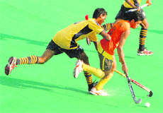 Players of Patiala and Jalandhar teams vie for the ball at Hockey Stadium in Sector 42, Chandigarh, on Wednesday. 
