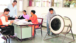 A GLADA employee checks the working of a fibre glass drum to be used for the draw in Ludhiana