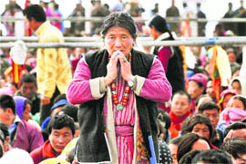 An old woman seeks the blessings of Tibetan spiritual leader-in-exile the Dalai Lama in Tawang on Wednesday