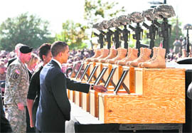 US President Obama and Michelle Obama pay respects to the victims of the Fort Hood shootings at a memorial service at Fort Hood, Texas, on Tuesday.