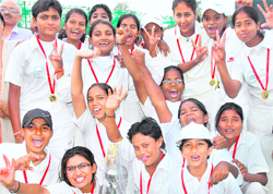 Winners in a cheerful mood after winning the Junior National Womens Cricket Championship at the Sector 16 Cricket Stadium