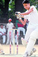 A batsman hits a shot in the Council Schools Cricket Tournament in Dehradun on Thursday. 