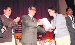 Dr Girijesh Pant, VC, Doon University , awards a young scientist at the state Science Congress at Pantnagar Agriculture University