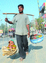 A man carries his child in a balance. 