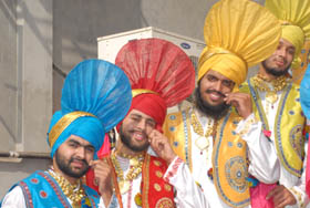  Bhangra artistes twist their moustaches before their performance at the PTU Youth Festival in Jalandhar.