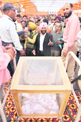 Irate applicants surround the stage in Ludhiana on Thursday.