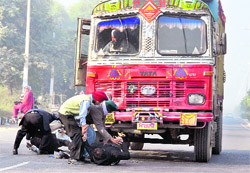 Passers-by rush to help the injured after the accident in Ludhiana on Thursday. 