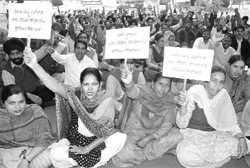 Members of the Private Colleges Non-Teaching Employees Union sit on a dharna in support of their demands at Khalsa College in Patiala on Friday.
