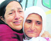 A Kashmiri woman breaks into tears as she sees off her relative leaving on Haj in Srinagar.