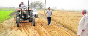 Villagers undertake repair work on a link road in Pakhowal block near Ahmedgarh.