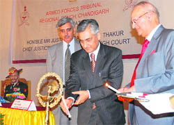 Punjab and Haryana High Court Chief Justice TS Thakur (2nd from right) along with Chairman of the Armed Forces Tribunal, Justice AK Mathur (right), lights a lamp to inaugurate the tribunals Chandigarh bench at Chandimandir on Saturday.