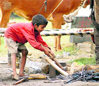 A boy works at a roadside in Dehradun