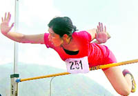 An athlete performs at a high-jump event in the District Athletics Meet in Dehradun 