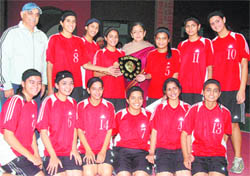Welham Girls with the trophy after winning the District Youth Basketball Championship in Dehradun on Sunday