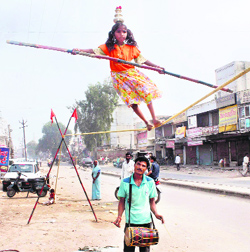 A little girl walks the rope to earn her living in Gurgaon.
